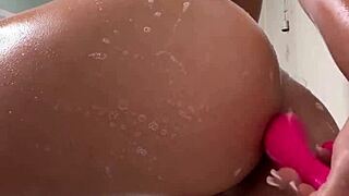 Asian cutie solo plays with pink vibrator in shower