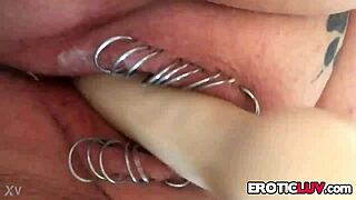 The nice woman plays with her new toy in her pierced pussy