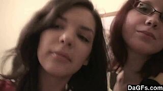 Two teen lesbians play with a camera in the bedroom