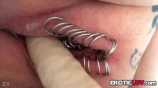 This horny babe works her pierced pussy with toys.