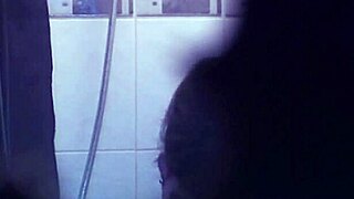 I watch this tattooed babe rip her clothes off while stripping in the shower, her body glistening under the water as she teases me with every move