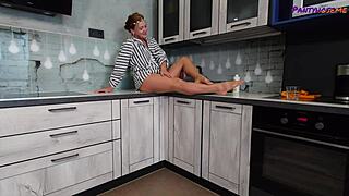 mature redhead iris teases with legs and feet in tan pantyhose