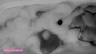 Curvy mature Kitty Hudson bathes with vibrator for orgasm