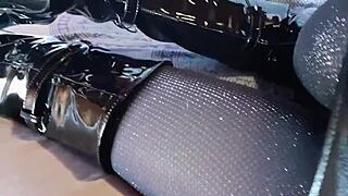 Petite amateur in total black lingerie fishnets pantyhose and over-the-knee boots shows ass