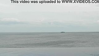 skinny student with cute legs relaxes by the infinity pool