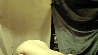 female slave in bdsm self-session with clamps and piss