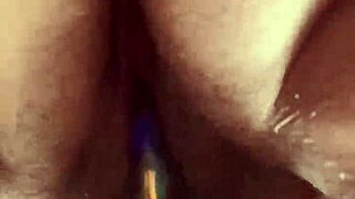 Solo hairy beaver glass dildo close up.