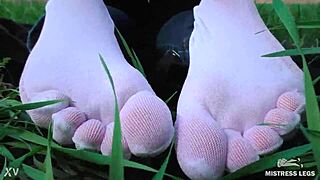 Goddess Feet In Cute White Socks With Jeans On The Spring Grass Field