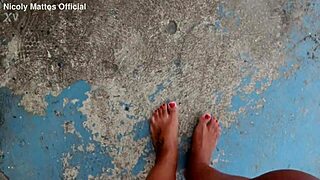 hot girl walks barefoot on beach with dirty feet soles. she shows wet foot fetish play outdoors in public