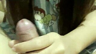 Asian girl gives her boyfriend an amazing handjob in the bedroom as a cute couple