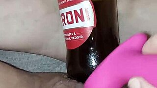 Muscular Gretala rubs juicy pussy lips with bottle in excited pregnant state.