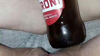 Muscular Gretala rubs juicy pussy lips with bottle in excited pregnant state.