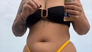 young african girl on usa beach wears tight yellow bikini to show swollen pussy and draw attention