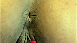 This hot ebony slut bends over to finger her shaved pussy and pierced clit.