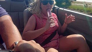 Squirting blonde babe fucks herself hard with dildo in convertible on busy highway!