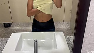 fingering her wet panties under miniskirt in public outdoors.