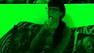 Beth's kinky goth domina smokes seductively in green light!