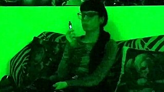 Beth's kinky goth domina smokes seductively in green light!