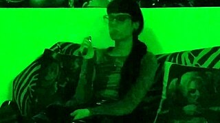 Beth's kinky goth domina smokes seductively in green light!