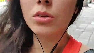 A Latina strolls publicly outdoors without panties flashing natural tits.