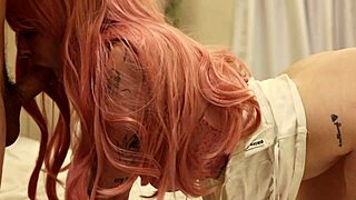 pink haired babe strapped tight in straight-jacket waits