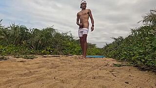 African dude jerks off and cums on beach