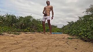 African dude jerks off and cums on beach