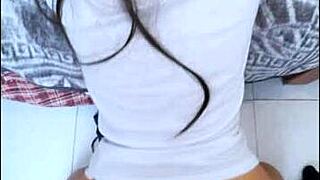 A homemade video shows a student girl kneeling as her friend inserts fully in amateur footage.