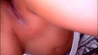 A homemade video shows a student girl kneeling as her friend inserts fully in amateur footage.