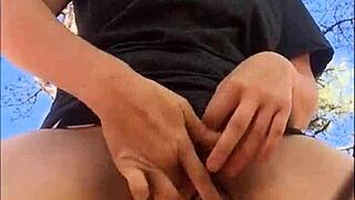 Horny girl pees and orgasms outdoors in pink thong