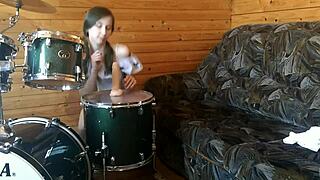 petite teen rams big dildo deep in shaved pussy on drumset
