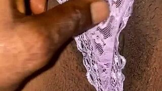 person removes panties slowly in private bedroom setting