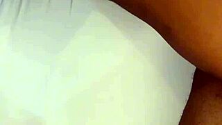 person removes panties slowly in private bedroom setting