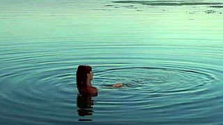 This mature babe bathes nude in the river