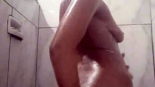 This naughty brunette masturbates in the shower POV