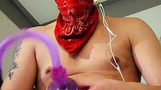 She strokes her big toy alone in stockings with tattoos