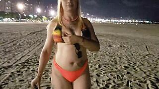 Blonde beach babe flashes tits and pussy in public voyeur scene