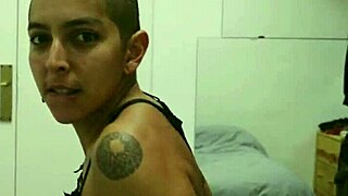 Short tattooed girl strips teasingly