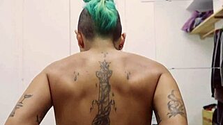 Short tattooed girl strips teasingly