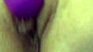 She uses a vibrator on her dry pussy lips during masturbation