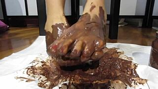 My feet with varnished nails all covered with chocolate cream