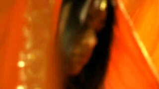 i'm watching this brunette indian girl undress and dance erotically, teasing with striptease.