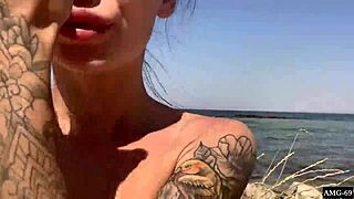 Masturbating right on the beach, what a risky thrill.