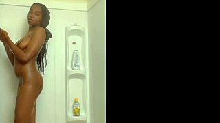 A black girl enjoys a sexy shower, bathing alone in the wet environment