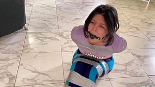 Girl struggles in barefoot bondage tape