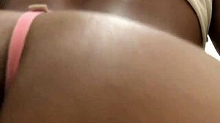 Ebony babe teasing with striptease in public bathroom