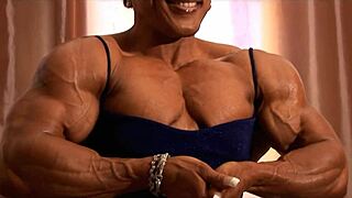 tall muscular bodybuilder women flex biceps in femdom session