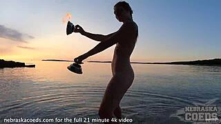 nude fire dancing on beach at sunset
